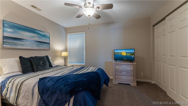 bedroom with a closet, visible vents, a ceiling fan, carpet flooring, and baseboards