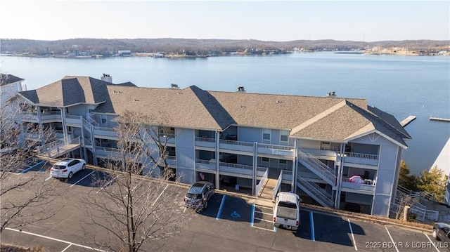 birds eye view of property featuring a water view