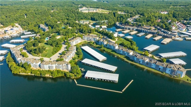 aerial view featuring a forest view and a water view