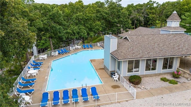 pool featuring a patio area and fence