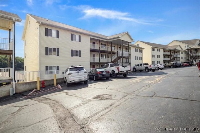 view of building exterior with uncovered parking