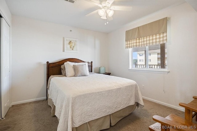 carpeted bedroom with a ceiling fan, visible vents, baseboards, and a closet