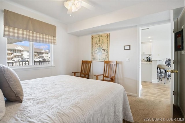 carpeted bedroom featuring baseboards