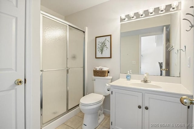 full bath with a stall shower, vanity, toilet, and tile patterned floors