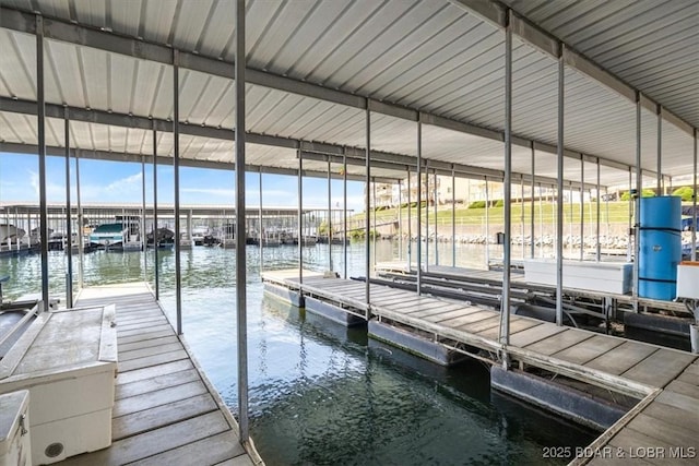 dock area with a water view and boat lift