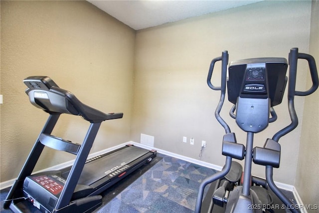 workout room featuring baseboards