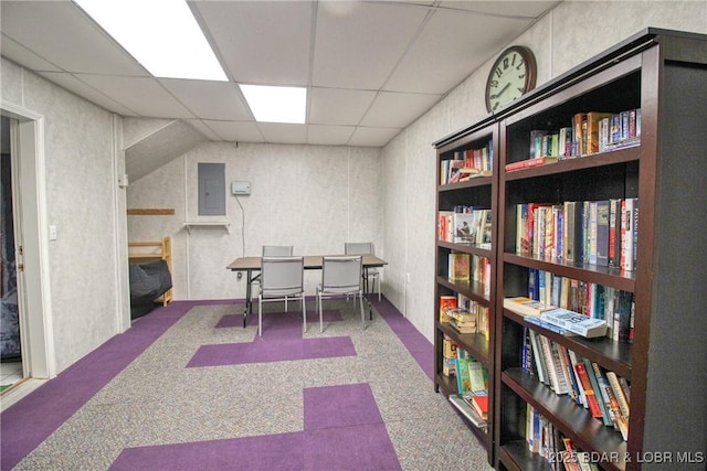 home office featuring a paneled ceiling, electric panel, and carpet flooring