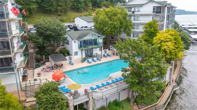 community pool with stairway and a patio