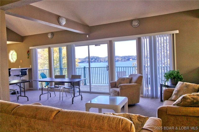 carpeted living room featuring lofted ceiling with beams and plenty of natural light