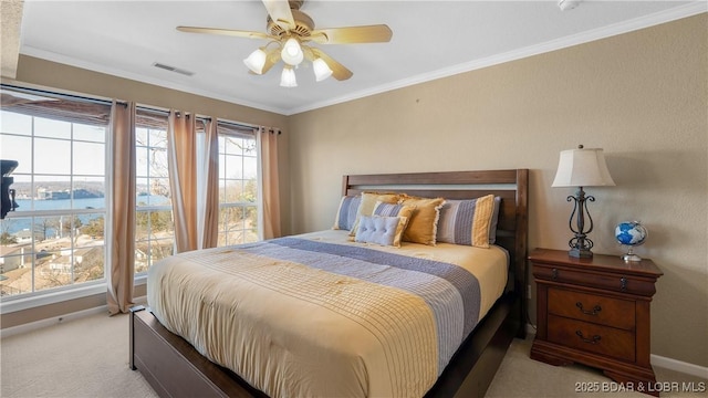 bedroom with light colored carpet, a ceiling fan, baseboards, visible vents, and crown molding