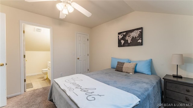 carpeted bedroom featuring baseboards, visible vents, connected bathroom, lofted ceiling, and ceiling fan