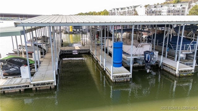 dock area with a water view and boat lift