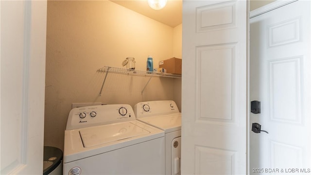 laundry area with laundry area and washer and clothes dryer