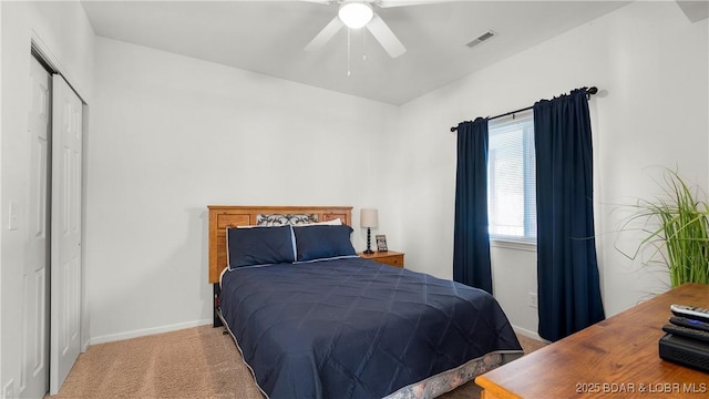 bedroom featuring light carpet, baseboards, visible vents, ceiling fan, and a closet