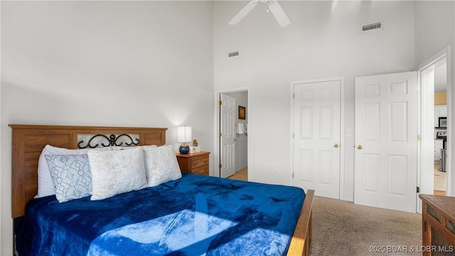 carpeted bedroom with ceiling fan, high vaulted ceiling, and visible vents