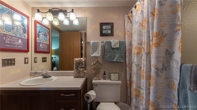 bathroom featuring toilet, curtained shower, a textured ceiling, and vanity