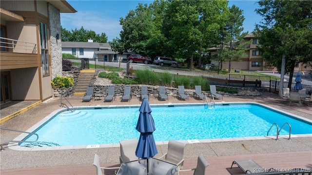 pool featuring a patio and fence