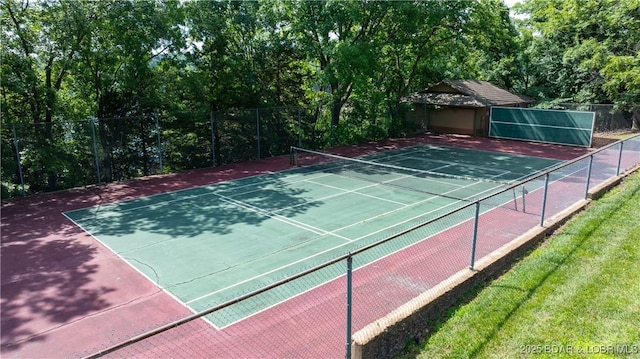 view of sport court featuring fence