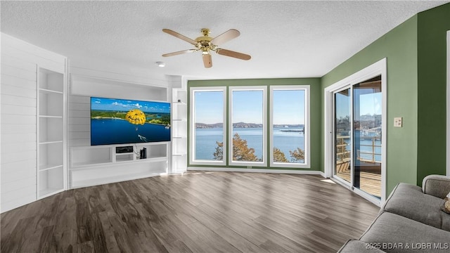 living room featuring ceiling fan, a textured ceiling, and wood finished floors