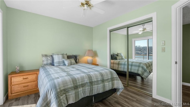 bedroom featuring a closet, wood finished floors, a ceiling fan, and baseboards