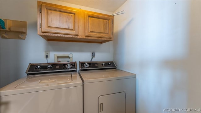 laundry area featuring independent washer and dryer and cabinet space