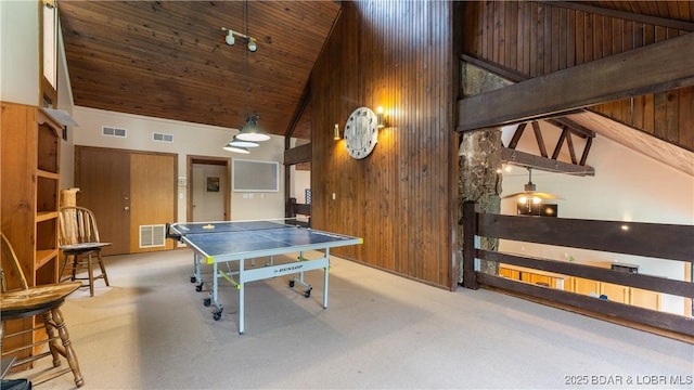 recreation room with high vaulted ceiling, wooden walls, and visible vents