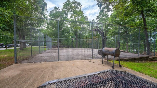 surrounding community with community basketball court and fence