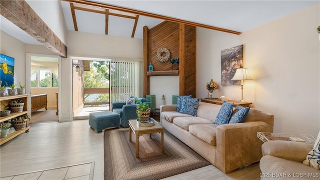 living room with a towering ceiling and wood finished floors