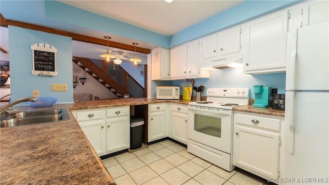 kitchen featuring white appliances, white cabinetry, a sink, and under cabinet range hood