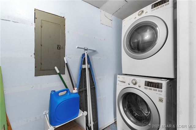 laundry area with stacked washer and dryer, laundry area, and electric panel