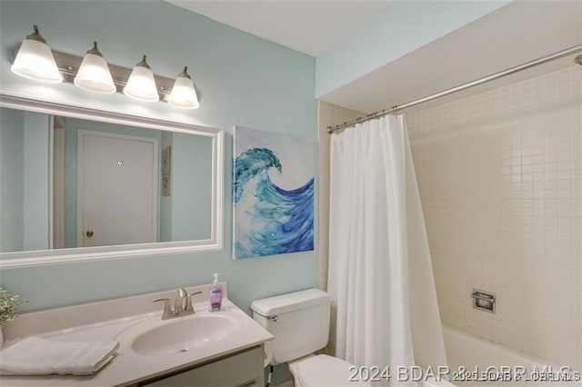 full bathroom with toilet, shower / tub combo with curtain, and vanity