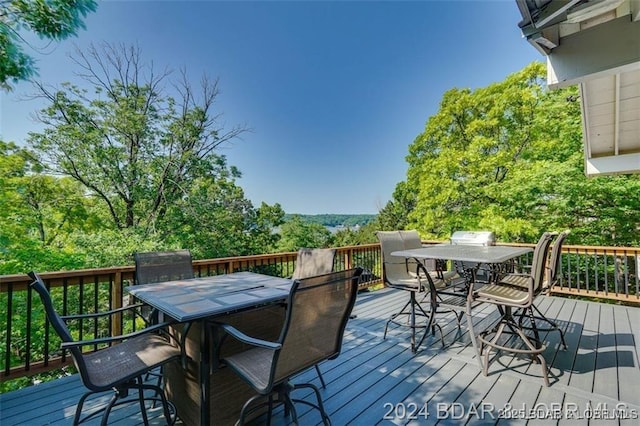 deck with outdoor dining area