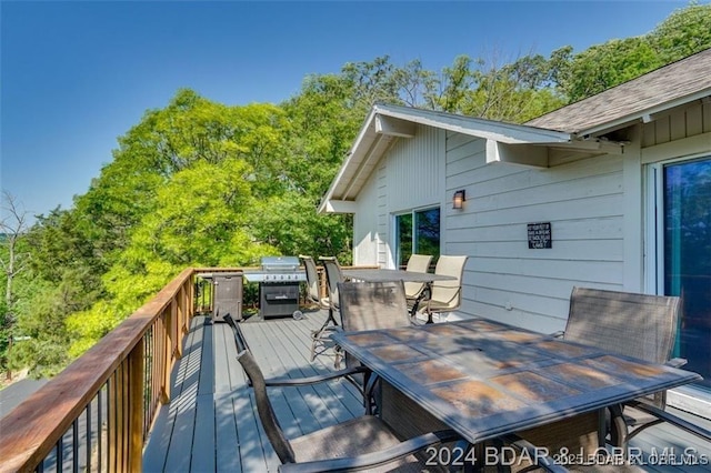 wooden terrace with outdoor dining area