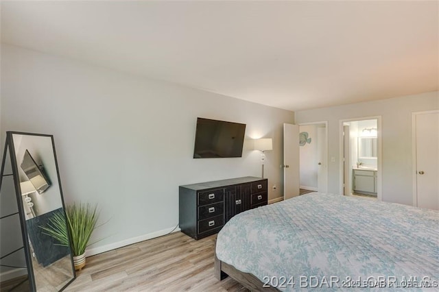 bedroom with light wood-style flooring and baseboards