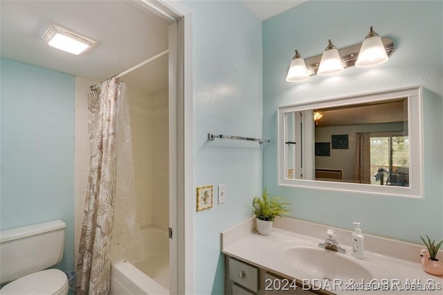 bathroom featuring shower / tub combo, vanity, and toilet