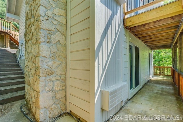 view of home's exterior with stone siding and stairs