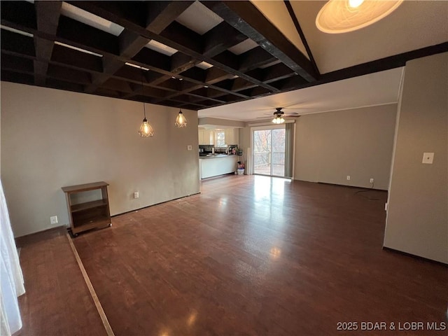 unfurnished living room featuring a ceiling fan, coffered ceiling, beamed ceiling, and wood finished floors