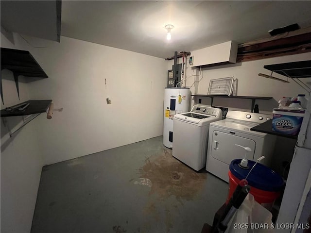 clothes washing area with water heater, laundry area, and washer and dryer