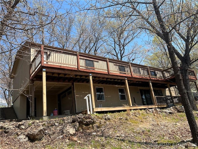 rear view of house featuring a deck