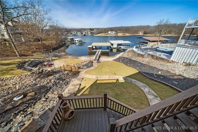 view of yard featuring a dock and a water view