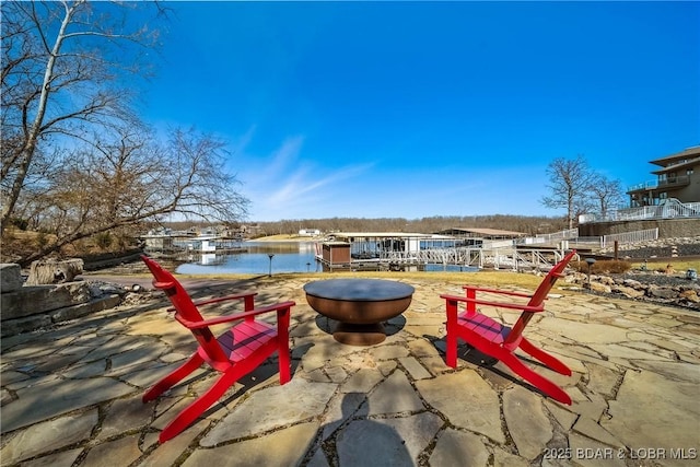 view of patio featuring a water view and a boat dock