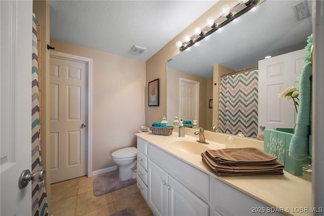 bathroom featuring toilet, vanity, visible vents, and tile patterned floors