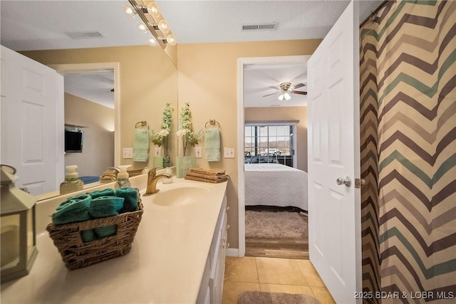 ensuite bathroom with connected bathroom, vanity, visible vents, and tile patterned floors