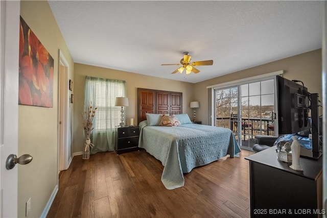 bedroom with access to outside, dark wood-style flooring, a ceiling fan, and baseboards