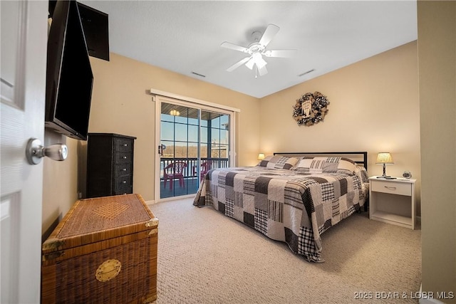 carpeted bedroom with a ceiling fan, access to outside, and visible vents