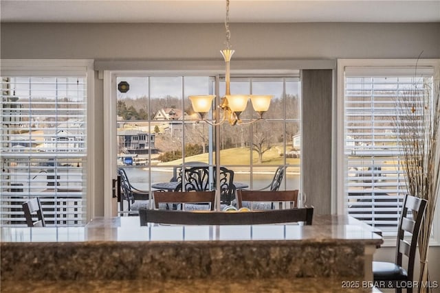 dining space with a notable chandelier and a wealth of natural light