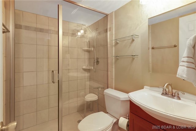 bathroom with a stall shower, vanity, and toilet