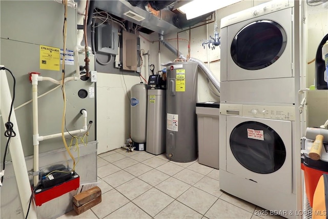 washroom with stacked washer and dryer, electric panel, visible vents, tile patterned floors, and electric water heater