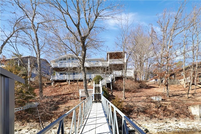 back of house with a balcony and stairs