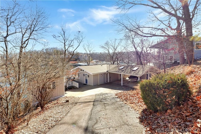 exterior space featuring an attached carport and concrete driveway